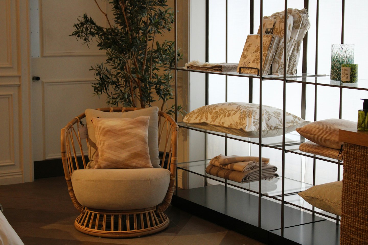 Rattan armchair and decorative shelving in a modern living space.